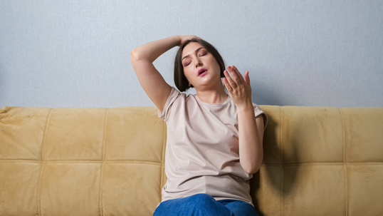 woman feeling the heat and sweating